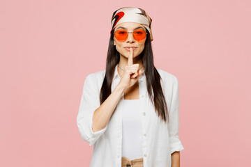 Young secret latin woman wear white shirt casual clothes sunglasses say hush be quiet with finger...