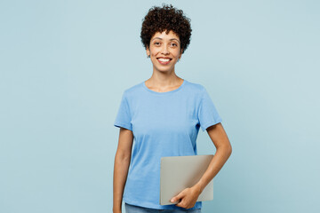 Young happy smiling smart cheerful IT woman of African American ethnicity wears t-shirt casual...