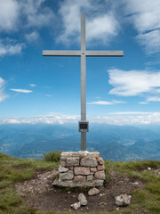 Iron cross at Canfedin mountain top in alp, Andalo and Molveno region
