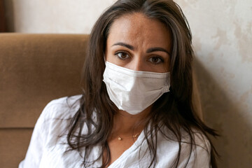 woman sitting on a chair with a protective mask , lifestyle concept