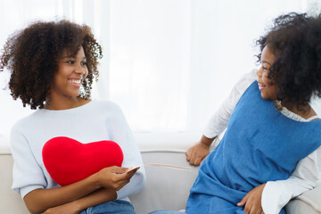 Happy cheerful little American - African ethnicity little girl and mother staying together, mom...