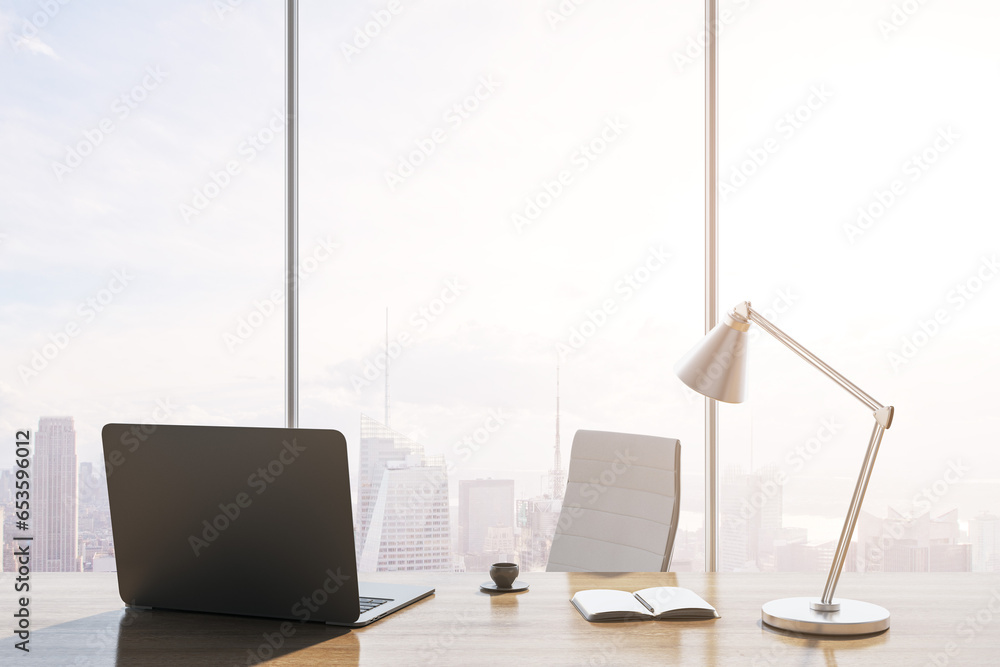 Poster close up of luxury backlit workplace with laptop, table lamp, coffee cup and panoramic window with c