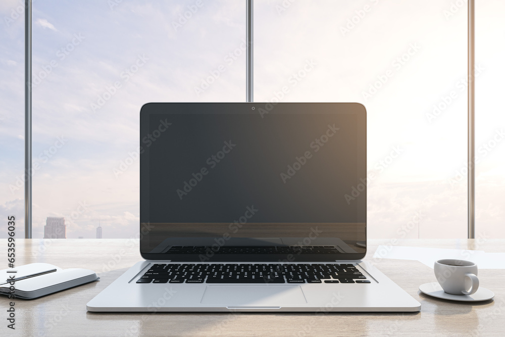 Poster close up of luxury workplace with empty mock up laptop screen, supplies, coffee cup and panoramic wi