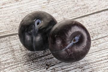 Two ripe sweet black plums