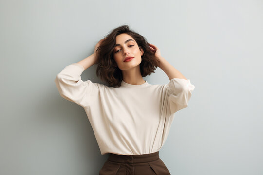 young woman giving pose, light-colored background minimalistic style