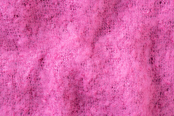 Pink merino wool handmade knitted blanket or plaid texture, soft and warm, cozy hygge concept. Close up of knitted blanket, merino wool background. Plaid made of pink wool yarn