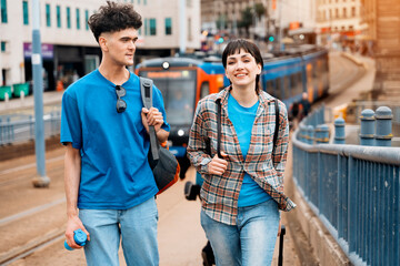 Outdoor portrait of couple having a fun time walking on street  in the city of England Enjoying travel concept