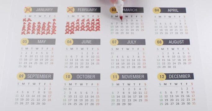 Person hand crossed out every day at year in paper calendar. Marking dates with red marker when task is done. The end of 2023 year. Passing time concept. annual calendar. Plan Organize.