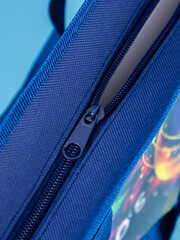 close up of the zipper on blue  bag background
