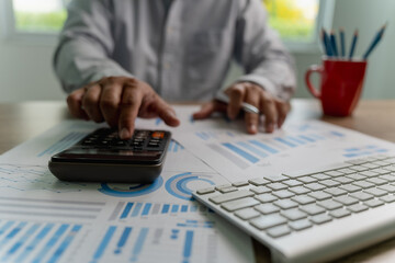 man using a calculator accountant working on desk budget and loan Close up Accounting analysis, tax finance, bank income savings budget