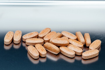 pills and vitamins on a stainless steel tray
