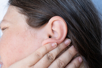 caucasian mature woman holding painful ear close up, hearing loss, Ear Discomfort, Hearing Test, Women's Health, Acute Otitis Media, Treatment and Care, Diagnosing and Treating, Preventing Ear Issues - obrazy, fototapety, plakaty