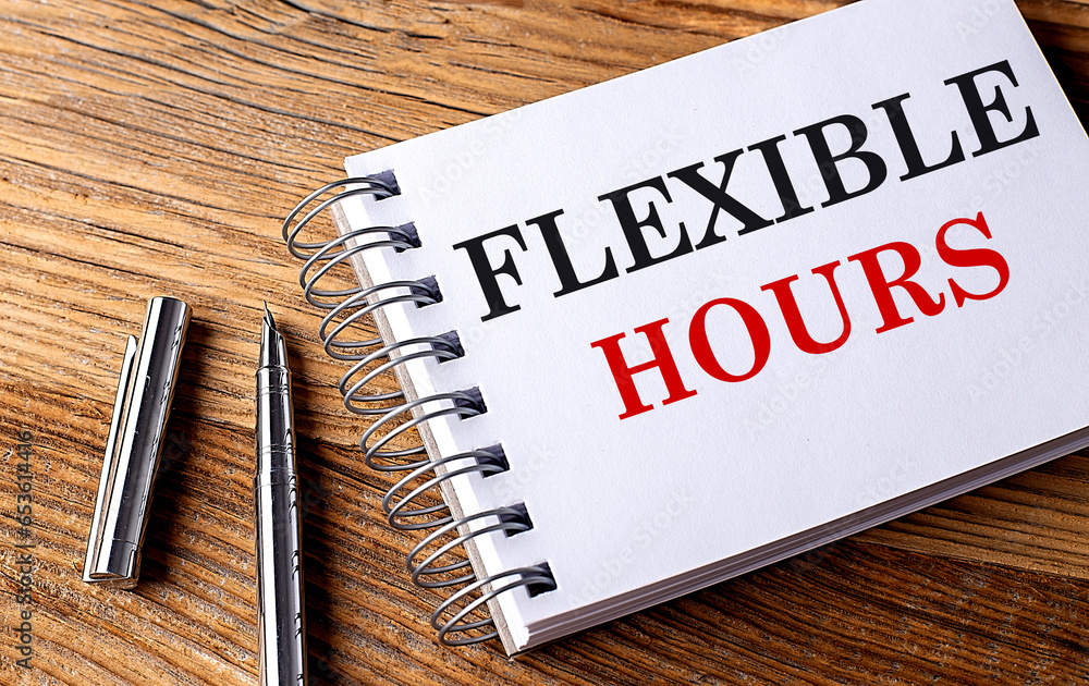 Poster flexible hours text on notebook with pen on wooden background