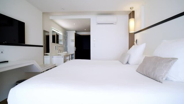 traveling from a hotel room to a spa, with its double bed, tv, air conditioning