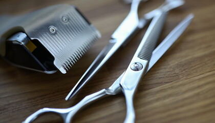 Close-up of hairdresser professional instrument. Metal tools laying on wooden table. Job profession...