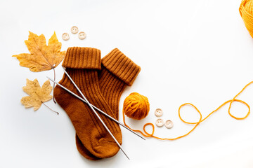 Set for knitting children's socks. Orange threads, knitting needles, buttons, centimeter.