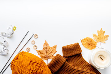 Set for knitting children's socks. Orange threads, knitting needles, buttons, centimeter.