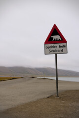 A warning sign against polar bears marking the end of the safe zone in Longyearbyen, Svalbard,...