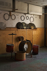 An incomplete percussion set abandoned in a dimly lit room in Pyramiden, Svalbard