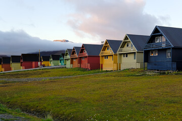 Fototapeta na wymiar A line of colourful Scandinavian houses on an overcast day in Longyearbyen, Svalbard, Norway