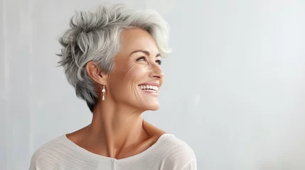 Foto op Plexiglas Woman in her sixties seventies, elderly elder older beautiful woman with gray hair is laughing and smiling, mature old woman with healthy face ans skin and white teeth © DigitalDreamscape