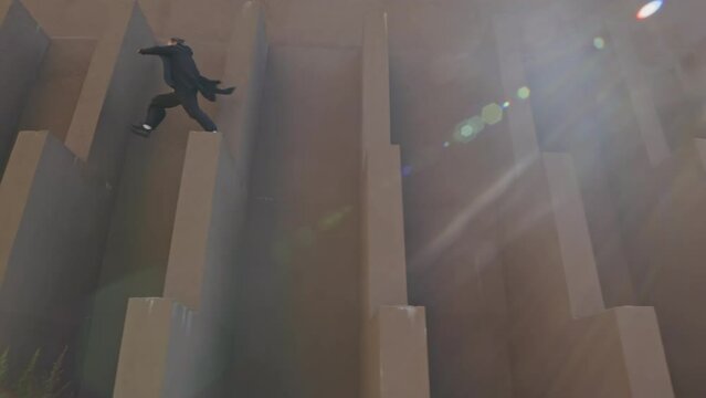 Low angle wide shot with lens flares of agile young parkour artist performing tricks outdoors, jumping over wall ledges one by one in city downtown