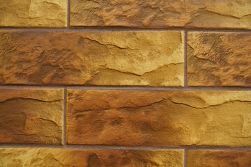 Macro of brick like brown embossed ceramic tiles siding