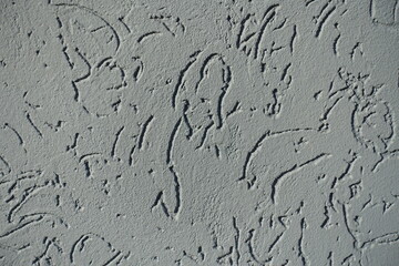 Close view of gray wall with stucco worm swirl finish
