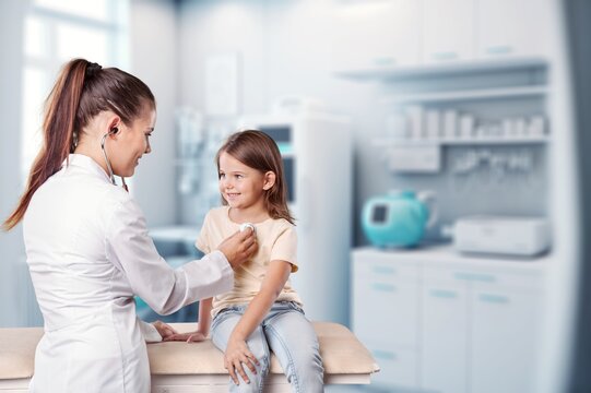 Pediatrician doctor examining cute child in clinic, AI generated image