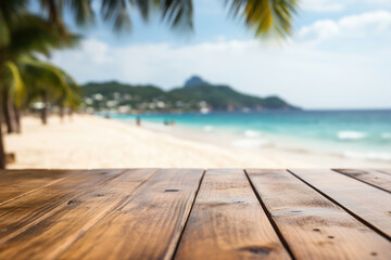 Empty wooden table with blur tropical beach on background. Copyspace for text - obrazy, fototapety, plakaty