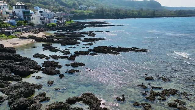 erial view of Pingtung seaside town on a sunny day with coral reefs, captured in 4K, showcasing Taiwan Island.