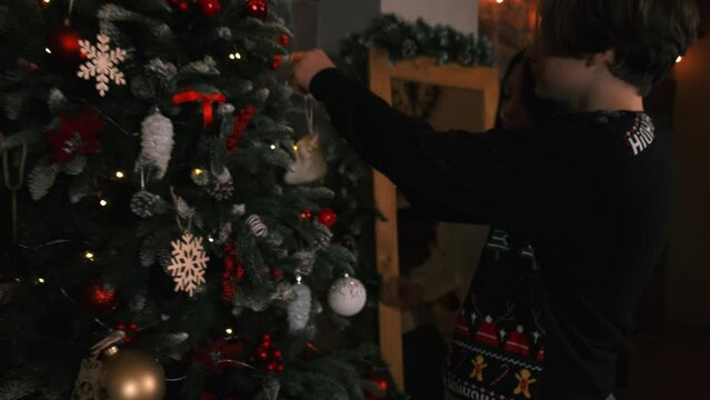 parents and dani decorate the Christmas tree together, family on New Year's Eve, family having fun on New Year's Eve, family holiday, New Year's holidays, New Year's Eve