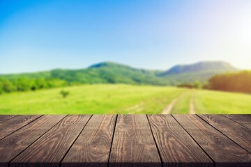 Wooden table on blur field background