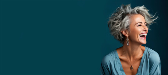 Portrait of a beautiful smiling elderly woman with gray hair - obrazy, fototapety, plakaty
