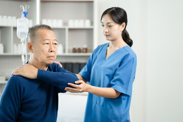 senior man doing exercise at clinic with physiotherapist. help of a personal trainer during a rehabilitation session.