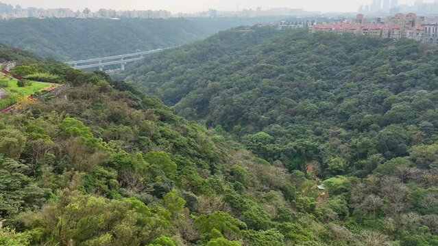 Beautiful highway and mountain road with green forest in 4K aerial view.