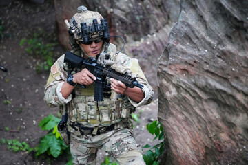 Military army soldiers tactical team, commando group moving cautiously in forest area, kneeling and...