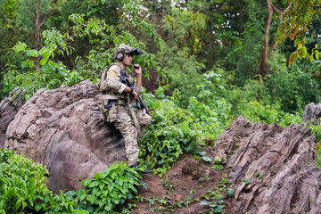 Military army soldiers tactical team, commando group moving cautiously in forest area, kneeling and...