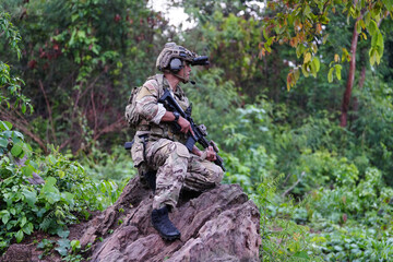 Military army soldiers tactical team, commando group moving cautiously in forest area, kneeling and looking around, covering comrades, controlling sectors. Commander showing halt or stop hand signal