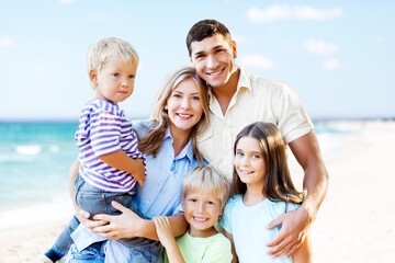 Happy cute family walking on beach,