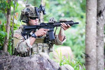 Military army soldiers tactical team, commando group moving cautiously in forest area, kneeling and looking around, covering comrades, controlling sectors. Commander showing halt or stop hand signal