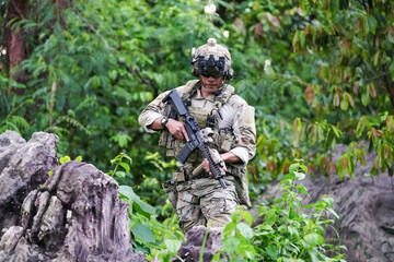 Military army soldiers tactical team, commando group moving cautiously in forest area, kneeling and...
