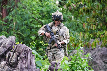 Military army soldiers tactical team, commando group moving cautiously in forest area, kneeling and looking around, covering comrades, controlling sectors. Commander showing halt or stop hand signal