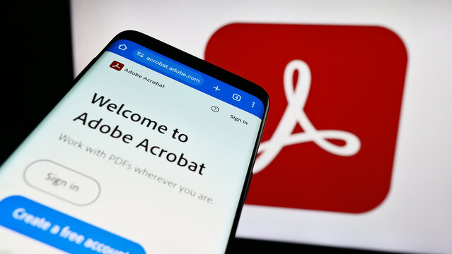 Stuttgart, Germany - 09-23-2023: Mobile phone with website of PDF management software Adobe Acrobat on screen in front of business logo. Focus on top-left of phone display.