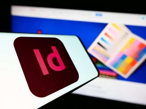 Stuttgart, Germany - 09-23-2023: Smartphone with logo of desktop publishing software Adobe InDesign on screen in front of company website. Focus on center of phone display.