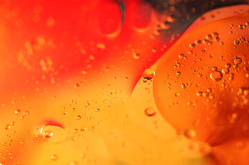 Oil in water, abstract background in yellow and red color tones