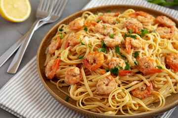 Baked Shrimp Scampi Linguine Pasta with Parsley on a Plate, side view. Close-up.