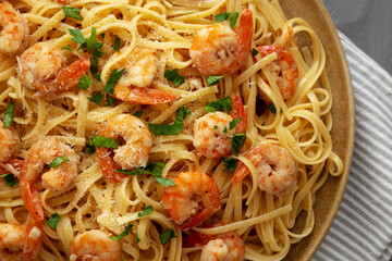 Baked Shrimp Scampi Linguine Pasta with Parsley on a Plate, top view. Close-up.