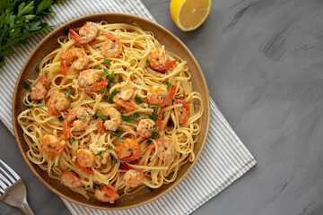 Baked Shrimp Scampi Linguine Pasta with Parsley on a Plate, top view. Flat lay, overhead, from...