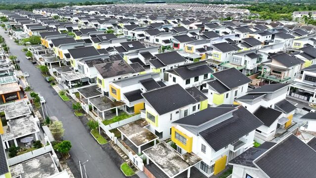 Aerial view of new white terraced houses on back to back streets in the suburbs of a large MALACCA city in the North of Malaysia with near shot 4K drone view